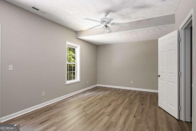 175 Hearth Way, Fairburn, GA 30213 - unfurnished bedroom featuring wood finished floors, baseboards, a textured ceiling, and ceiling fan