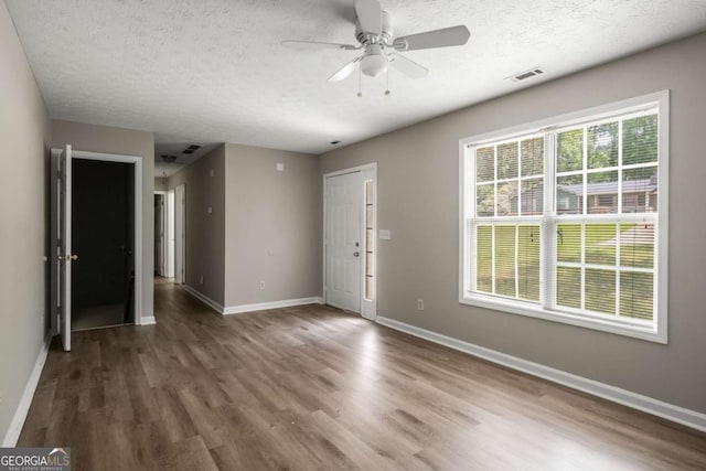 175 Hearth Way, Fairburn, GA 30213 - spare room featuring wood finished floors, a textured ceiling, a ceiling fan, and baseboards