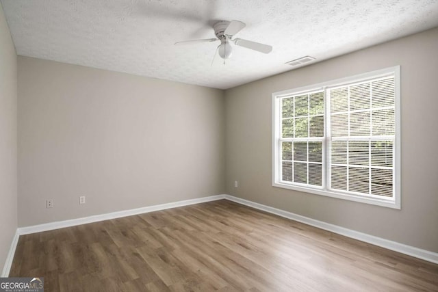 175 Hearth Way, Fairburn, GA 30213 - spare room with wood finished floors, a textured ceiling, and baseboards