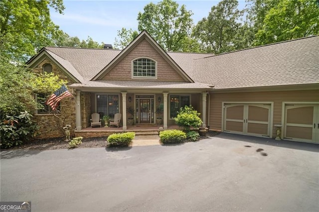 15 Sconti Knoll Dr, Jasper, GA 30143 - craftsman-style house featuring covered porch, driveway, an attached garage, stone siding, and roof with shingles