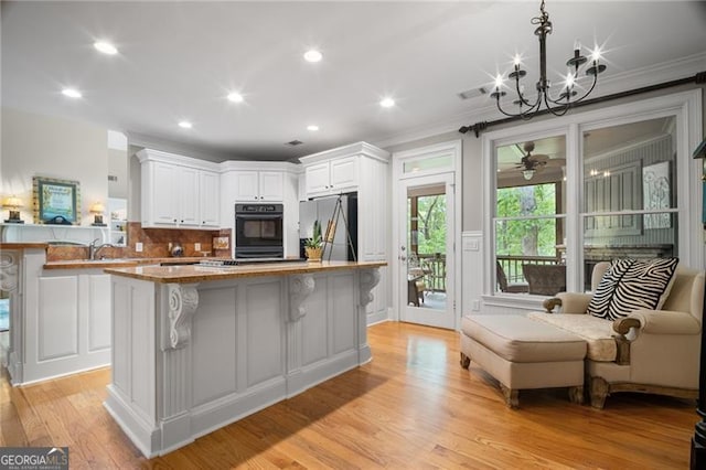15 Sconti Knoll Dr, Jasper, GA 30143 - kitchen with freestanding refrigerator, white cabinetry, a chandelier, recessed lighting, and a breakfast bar