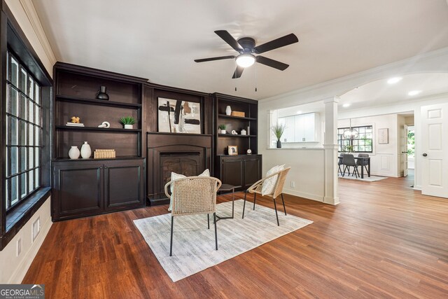 3708 Canadian Way, Tucker, GA 30084 - living area with ornamental molding, decorative columns, wood finished floors, a fireplace, and a ceiling fan