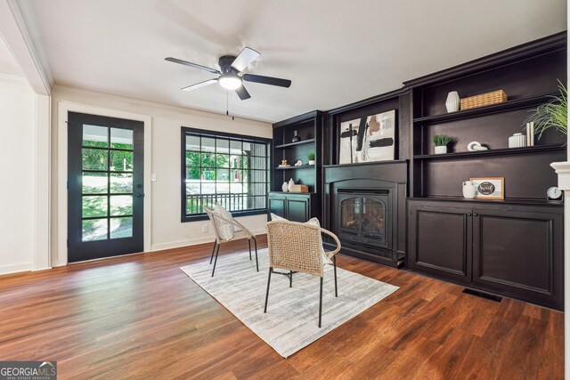 3708 Canadian Way, Tucker, GA 30084 - living area featuring a glass covered fireplace, ceiling fan, dark wood finished floors, ornamental molding, and baseboards