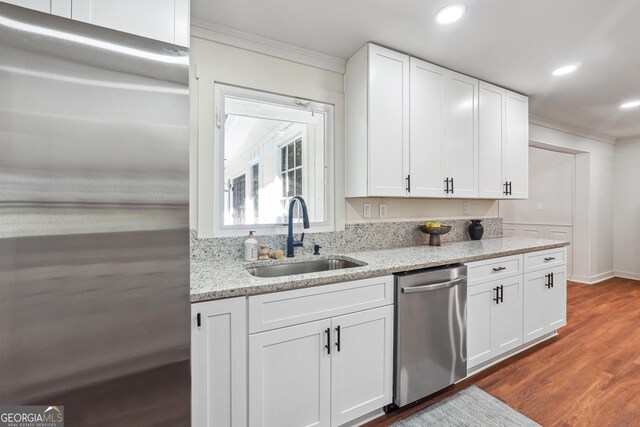 3708 Canadian Way, Tucker, GA 30084 - kitchen with stainless steel appliances, a sink, ornamental molding, dark wood-style floors, and light stone counters