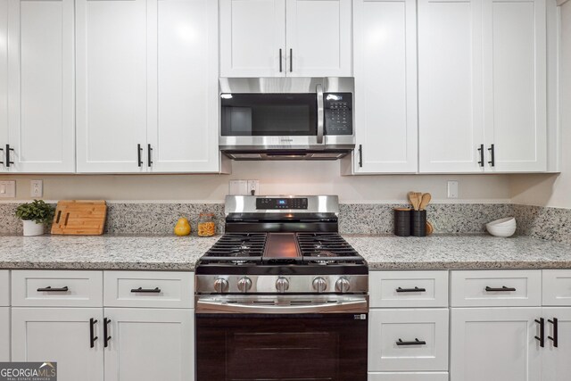 3708 Canadian Way, Tucker, GA 30084 - kitchen featuring stainless steel appliances, white cabinetry, and light stone counters