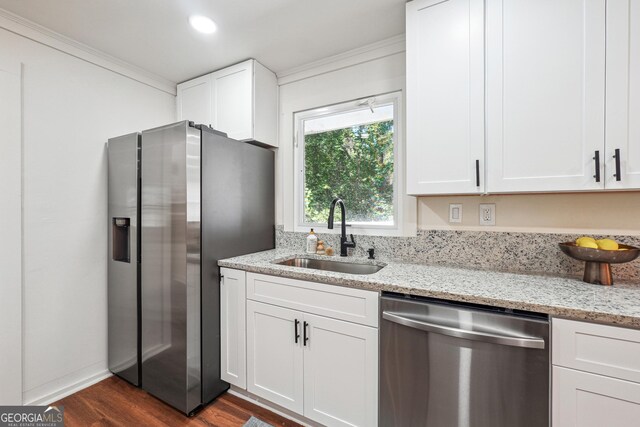 3708 Canadian Way, Tucker, GA 30084 - kitchen featuring appliances with stainless steel finishes, a sink, white cabinetry, dark wood-type flooring, and crown molding