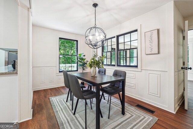 3708 Canadian Way, Tucker, GA 30084 - dining space with dark wood-style flooring, a chandelier, wainscoting, and a decorative wall
