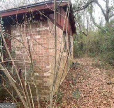 view of side of home featuring brick siding