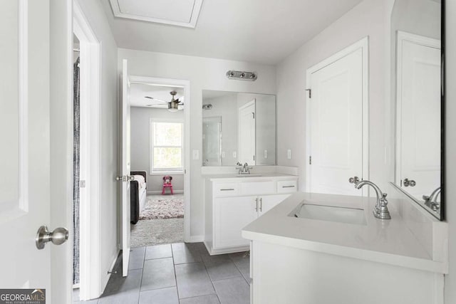 full bath with two vanities, tile patterned floors, ceiling fan, and baseboards