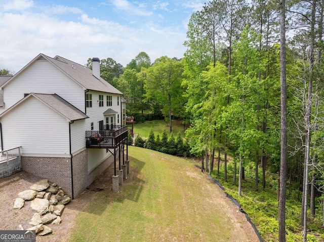 view of green lawn featuring a wooden deck