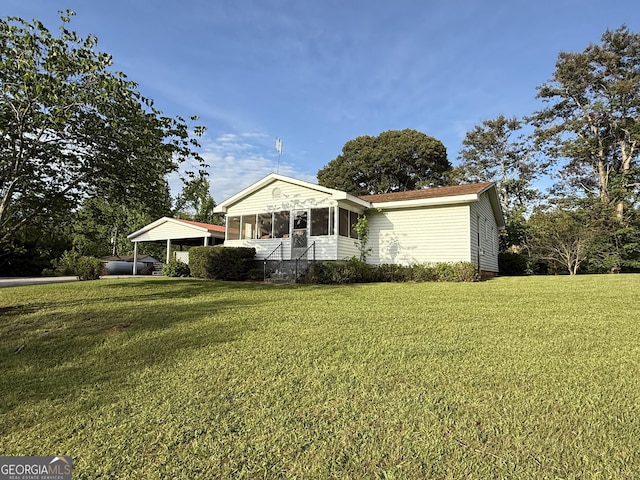 view of front of home featuring a front lawn and a sunroom