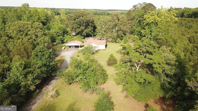 view from above of property with a heavily wooded area