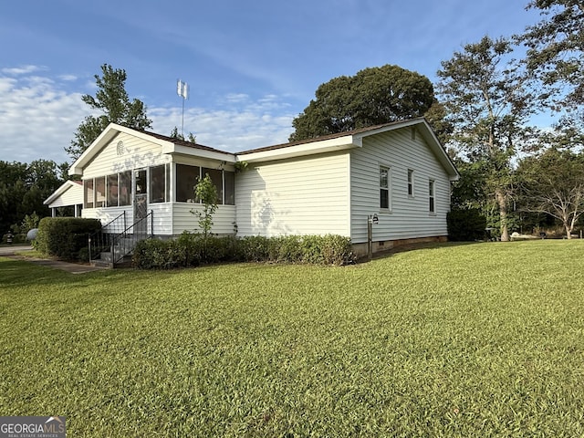 view of property exterior with a sunroom and a yard