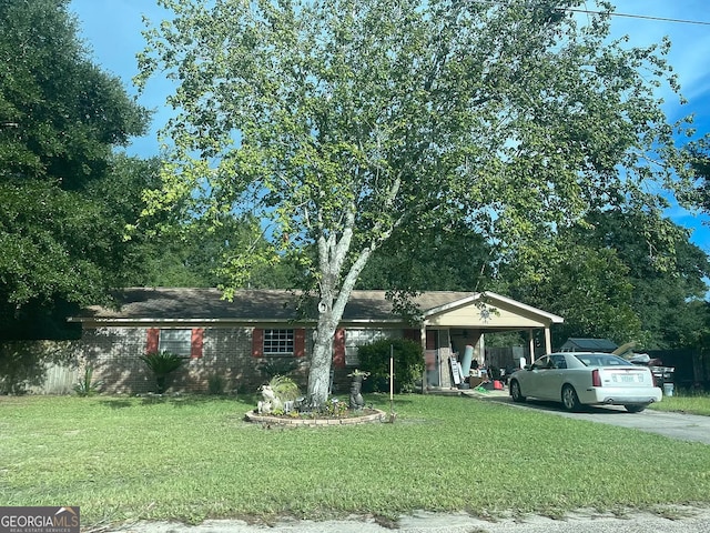 view of front of house featuring a front yard, concrete driveway, and an attached carport