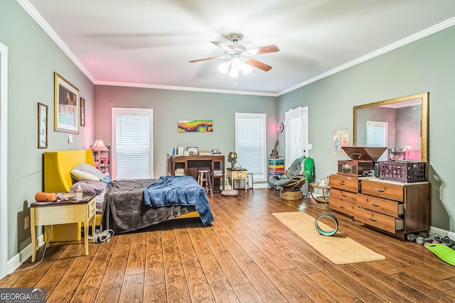 bedroom featuring hardwood / wood-style floors, crown molding, and ceiling fan