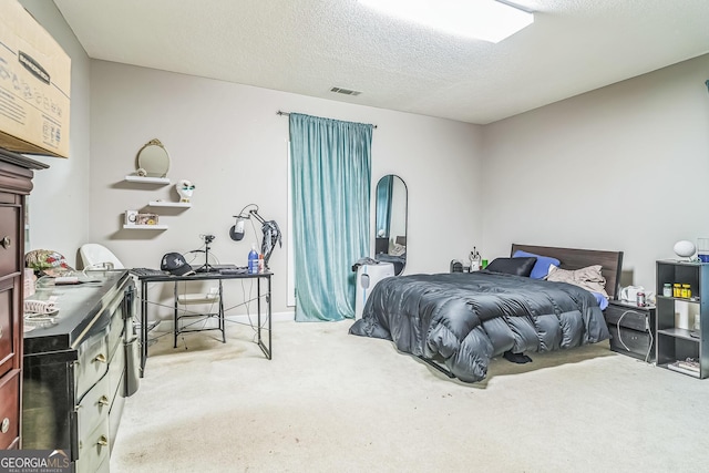 bedroom featuring carpet floors and a textured ceiling