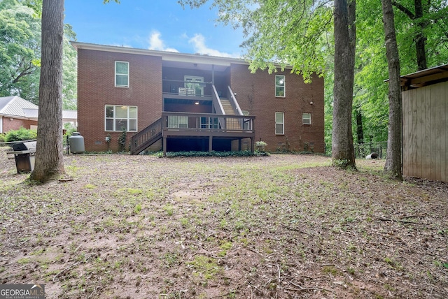 back of property with stairway and brick siding