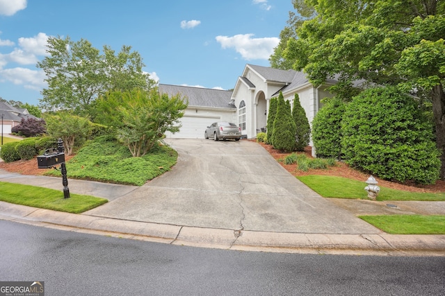 132 Eagles Club Dr, Stockbridge, GA 30281 - view of front of property with a garage, asphalt driveway, and stucco siding