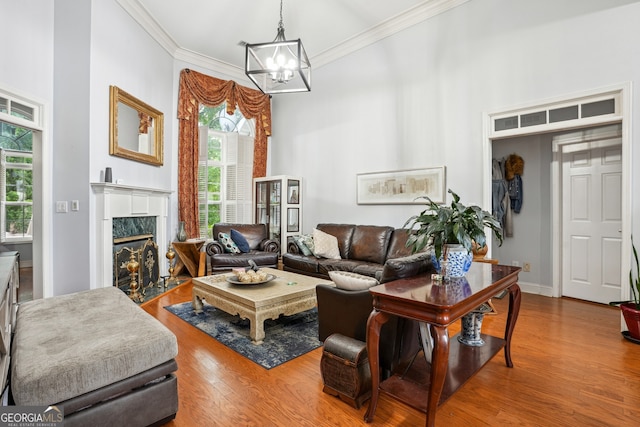 132 Eagles Club Dr, Stockbridge, GA 30281 - living area featuring ornamental molding, wood finished floors, a chandelier, and a premium fireplace