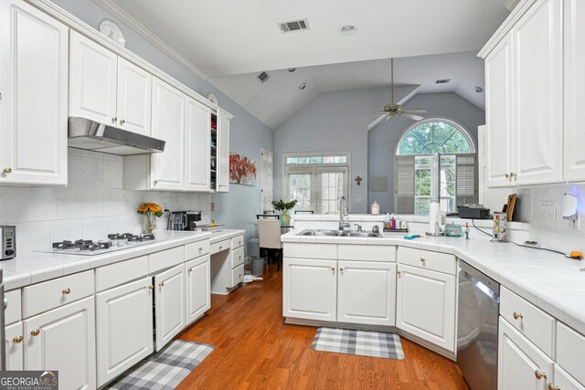 132 Eagles Club Dr, Stockbridge, GA 30281 - kitchen with stainless steel dishwasher, white gas stovetop, under cabinet range hood, a ceiling fan, and white cabinetry