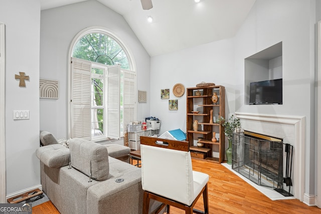 132 Eagles Club Dr, Stockbridge, GA 30281 - living area featuring ceiling fan, light wood finished floors, a tile fireplace, and high vaulted ceiling