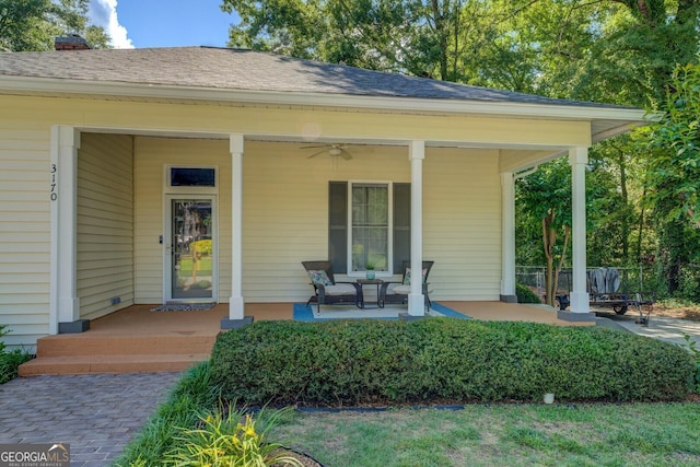 entrance to property featuring covered porch and ceiling fan