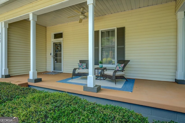 wooden deck featuring covered porch and a ceiling fan
