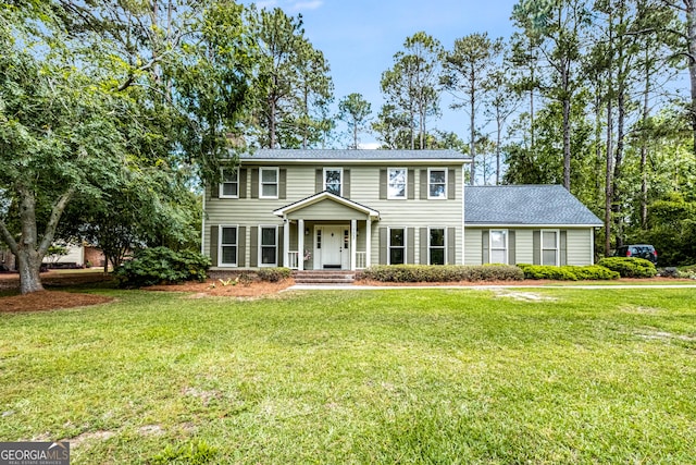 colonial-style house with a front lawn