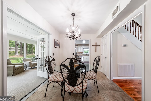 dining space with plenty of natural light, a chandelier, and baseboards