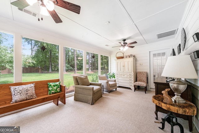 sunroom featuring ceiling fan and plenty of natural light