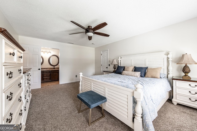 carpeted bedroom with a ceiling fan, connected bathroom, a textured ceiling, and baseboards