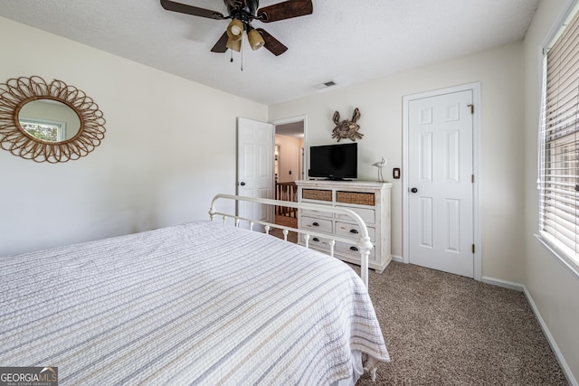 carpeted bedroom with baseboards and a ceiling fan