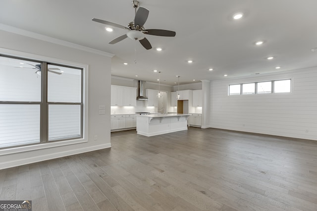 1023 Harvest Park Ln, Suwanee, GA 30024 - unfurnished living room featuring crown molding, ceiling fan, baseboards, wood finished floors, and recessed lighting