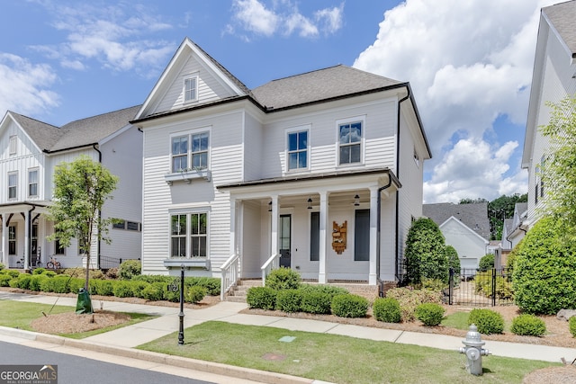 1023 Harvest Park Ln, Suwanee, GA 30024 - view of front of house with a porch, fence, and roof with shingles