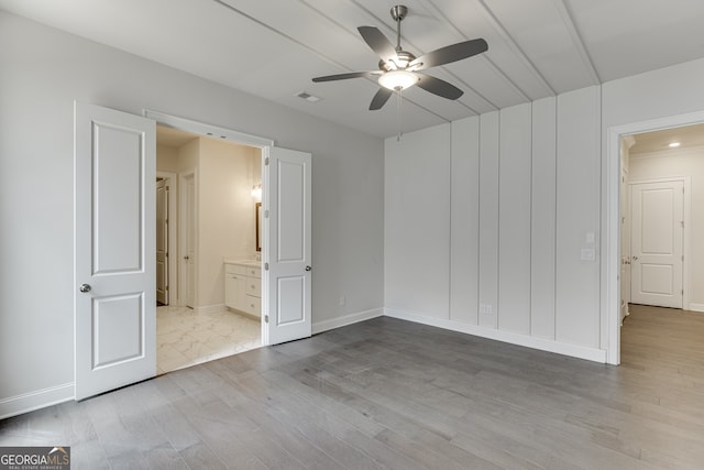 1023 Harvest Park Ln, Suwanee, GA 30024 - unfurnished bedroom featuring wood finished floors, baseboards, connected bathroom, and a ceiling fan
