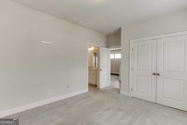 1023 Harvest Park Ln, Suwanee, GA 30024 - unfurnished bedroom with light carpet, baseboards, a closet, and connected bathroom