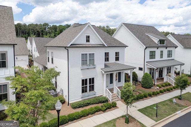 1023 Harvest Park Ln, Suwanee, GA 30024 - view of front of property featuring a porch, a standing seam roof, metal roof, and a shingled roof