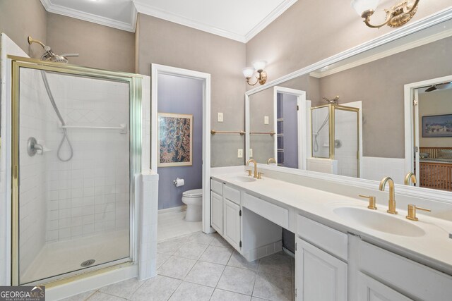 full bath featuring tile patterned floors, a shower stall, toilet, double vanity, and crown molding