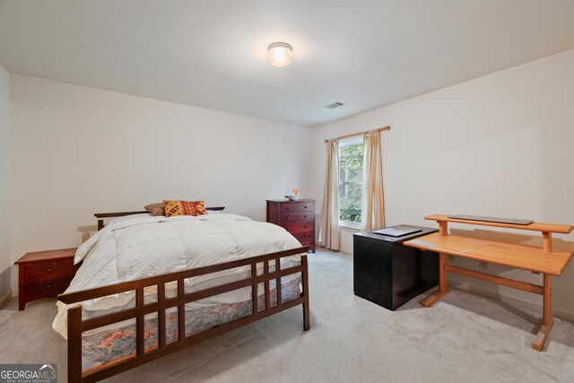 bedroom with light carpet and baseboards