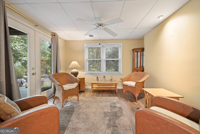 sitting room with ceiling fan and wood finished floors