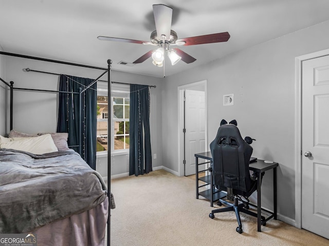 bedroom with light colored carpet, baseboards, and a ceiling fan