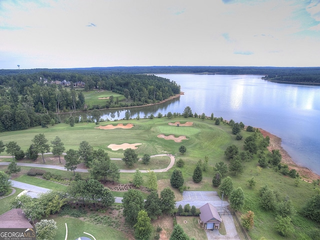 drone / aerial view with a water view and view of golf course