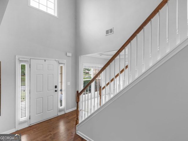 973 Buckhorn Bnd, Locust Grove, GA 30248 - entryway featuring stairway, a towering ceiling, healthy amount of natural light, wood finished floors, and baseboards