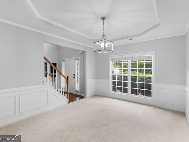 973 Buckhorn Bnd, Locust Grove, GA 30248 - unfurnished dining area featuring a tray ceiling, stairway, carpet, wainscoting, and a chandelier
