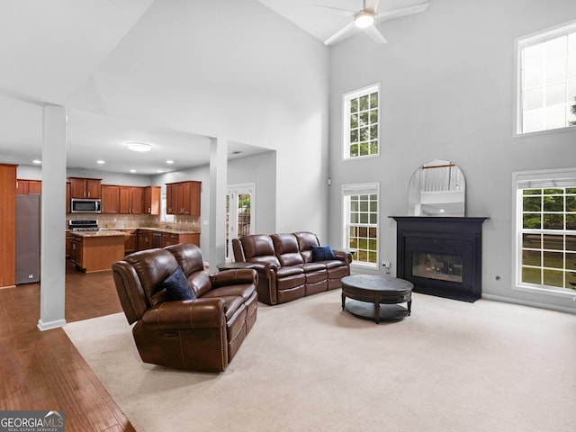 973 Buckhorn Bnd, Locust Grove, GA 30248 - living area featuring high vaulted ceiling, a ceiling fan, a glass covered fireplace, dark wood finished floors, and recessed lighting