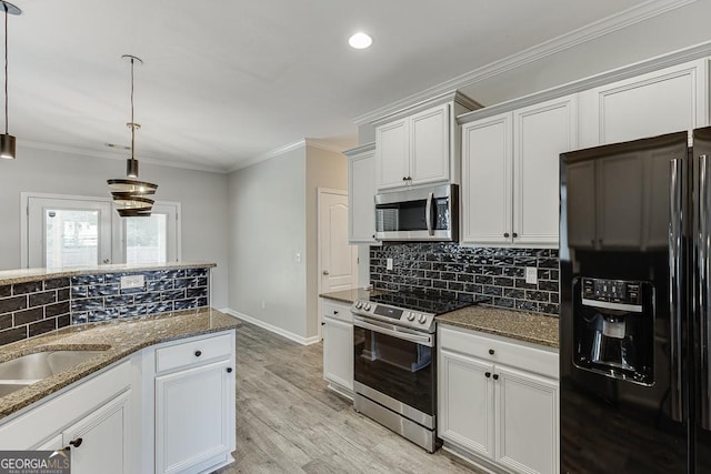 9565 Rushmore Cir, Braselton, GA 30517 - kitchen featuring appliances with stainless steel finishes, dark stone countertops, decorative backsplash, pendant lighting, and white cabinets