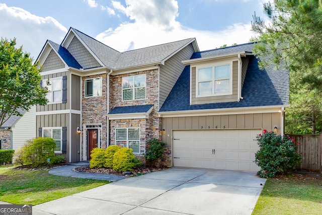 9565 Rushmore Cir, Braselton, GA 30517 - view of front of property with board and batten siding, concrete driveway, stone siding, fence, and a garage