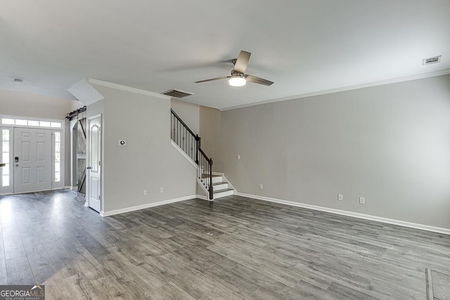 9565 Rushmore Cir, Braselton, GA 30517 - unfurnished living room with ceiling fan, crown molding, wood finished floors, stairway, and baseboards
