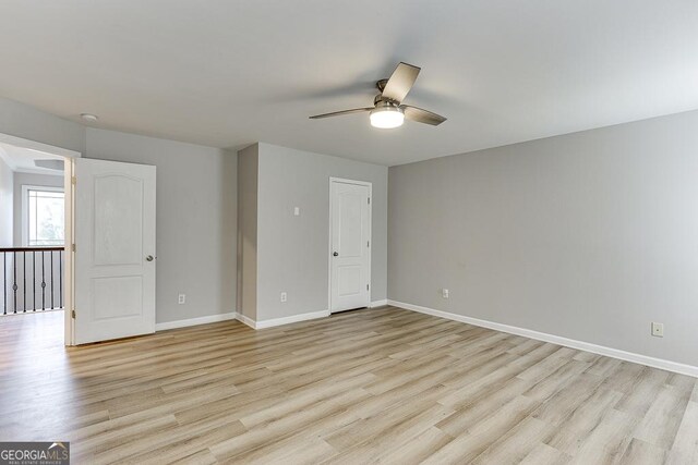 9565 Rushmore Cir, Braselton, GA 30517 - empty room featuring a ceiling fan, light wood-style floors, and baseboards