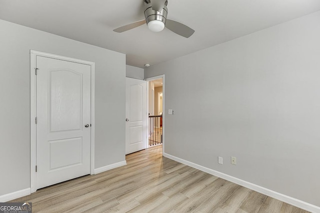 9565 Rushmore Cir, Braselton, GA 30517 - unfurnished bedroom featuring light wood-style flooring, baseboards, and ceiling fan